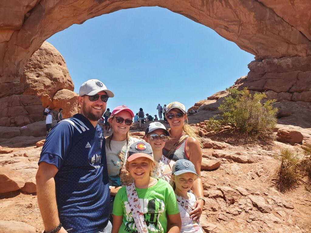 Family posing in front of a mountain / rock structure