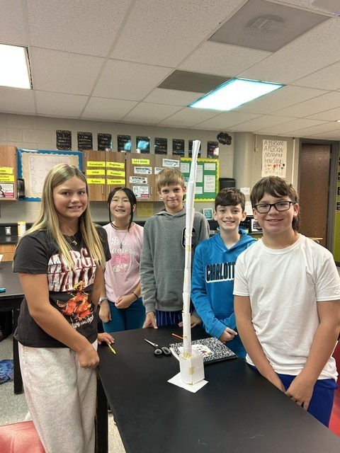 6th grade science students posing with their tower experiment