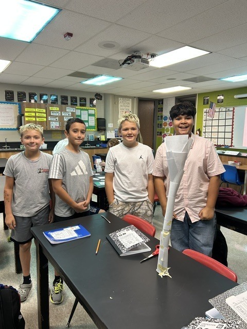 6th grade science students posing with their tower experiment