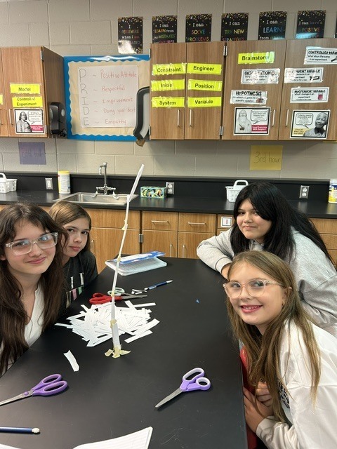 6th grade science students posing with their tower experiment