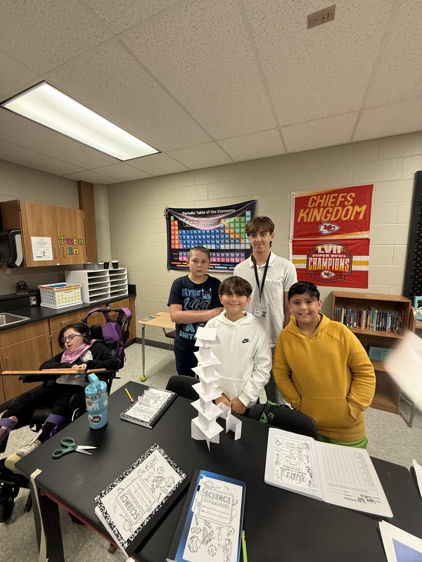 6th grade science students posing with their tower experiment