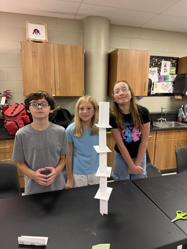 6th grade science students posing with their tower experiment