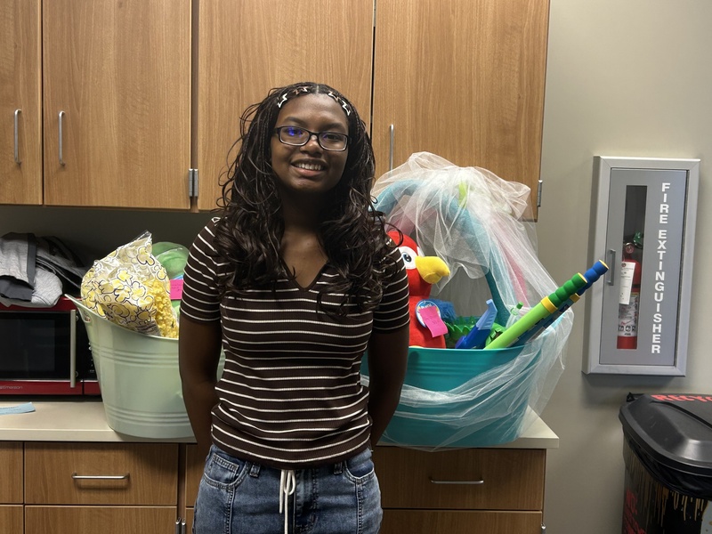 8th Grade student posing with her fundraising items