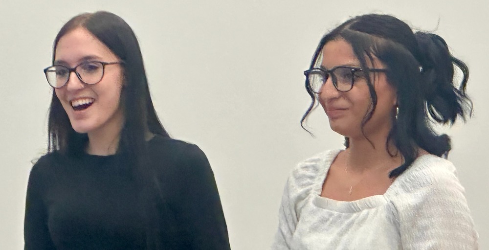 LCHS students Olivia Thomas and Sorianna Lugo talk during the April 8 board of education meeting