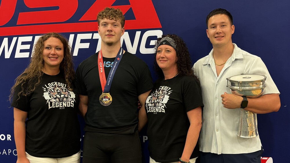 Zane Sanchez with family and coaches at world powerlifting competition in Florida