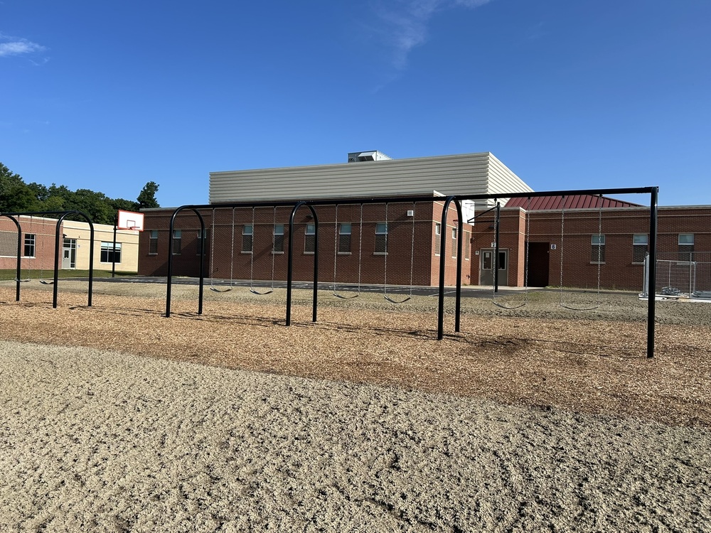 Photo of swing set and basketball court at Rolland-Warner