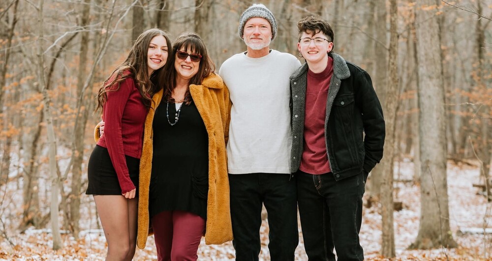 The Grzyb family outside on a snowy day posing for a photo