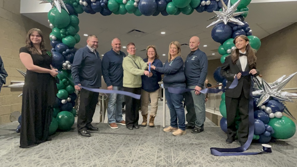 PAC ribbon cutting with board members, students