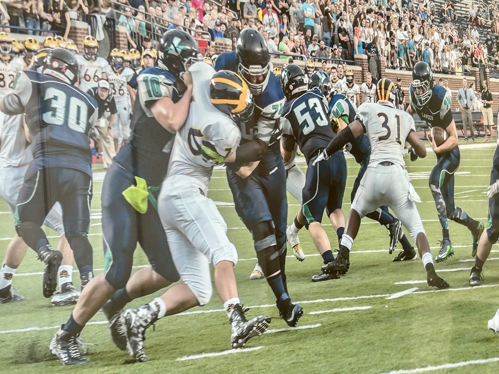 Photo of Lapeer and Clarkston football teams at Michigan Stadium