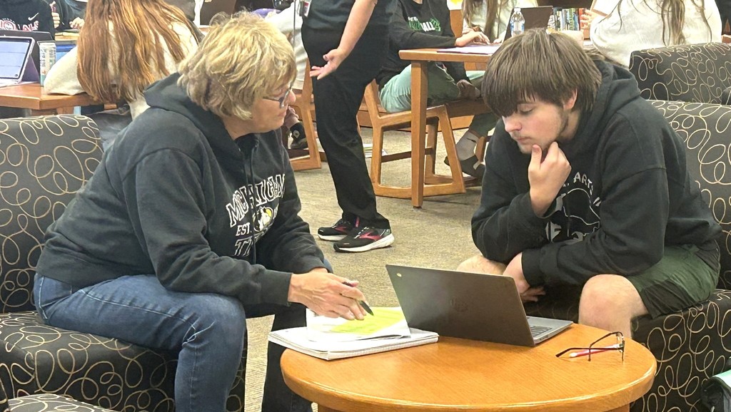 high school counselor advising a high school senior