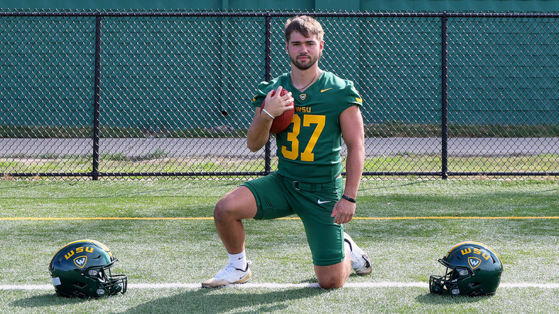 Brayden McKenna posing in his Wayne State football uniform