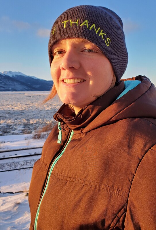 Andrea Cook outside in a brown coat and winter cap.