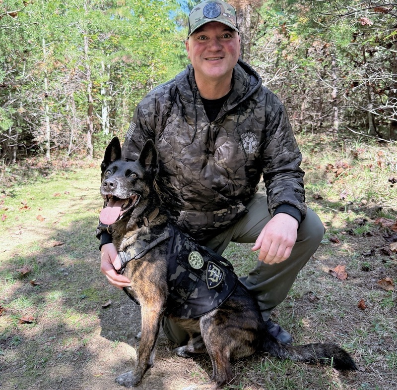 Jason Johnson outdoors with a police dog