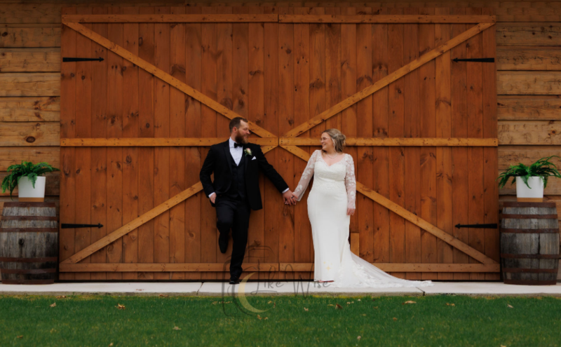 Married couple in front of brown doors