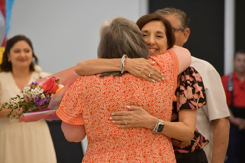 Librarian of the Year Ana Teresa Garcia hugged by family member
