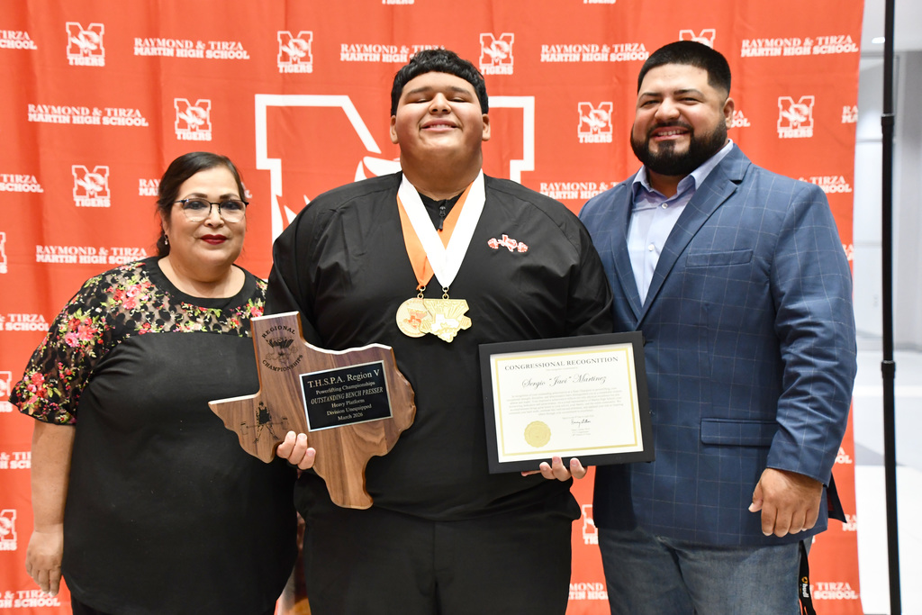 group picture of javi and his mom and coach huron