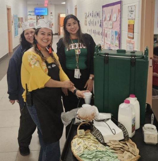 Leadership team walking around serving Starbucks to our teachers