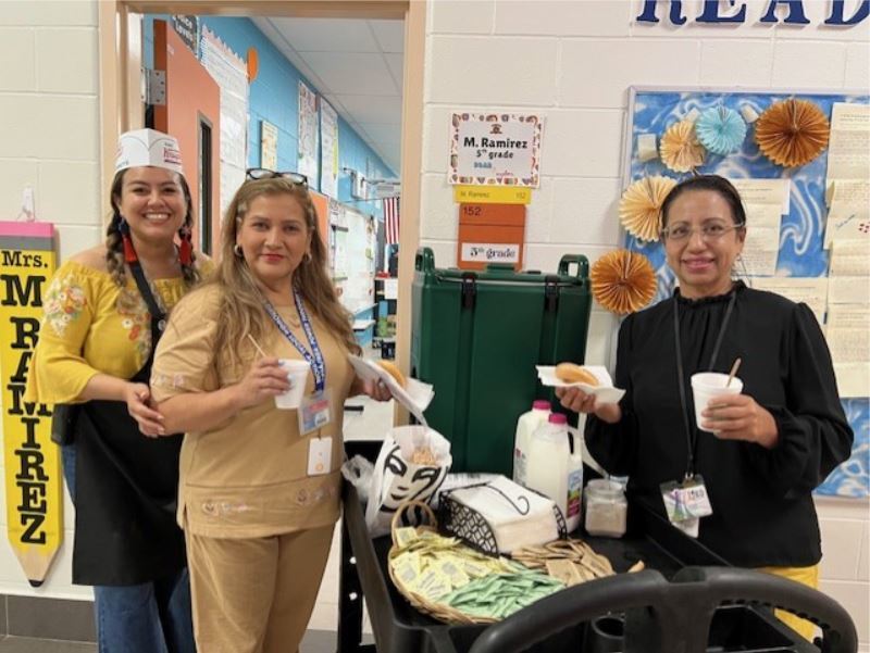 Leadership team walking around serving Starbucks to our teachers