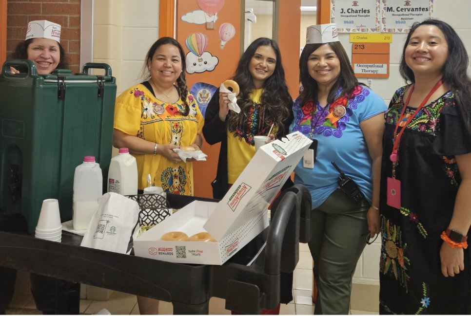 Leadership team walking around serving Starbucks to our teachers