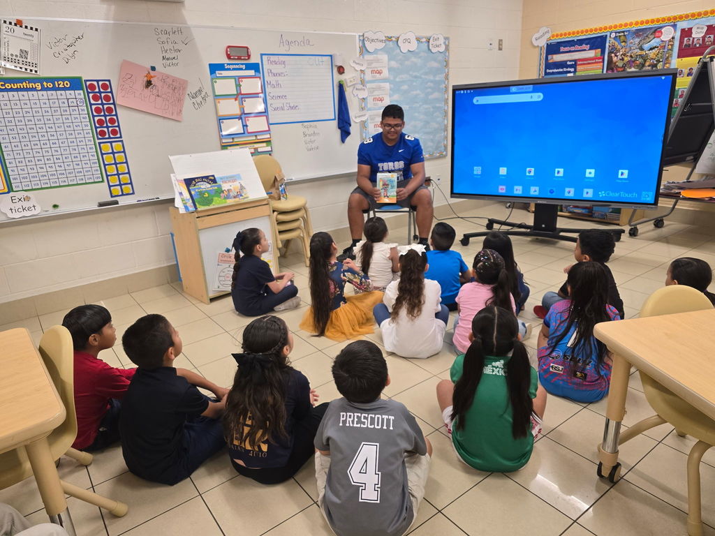 CHS Football team came in to GREET and read to our Kinder students.