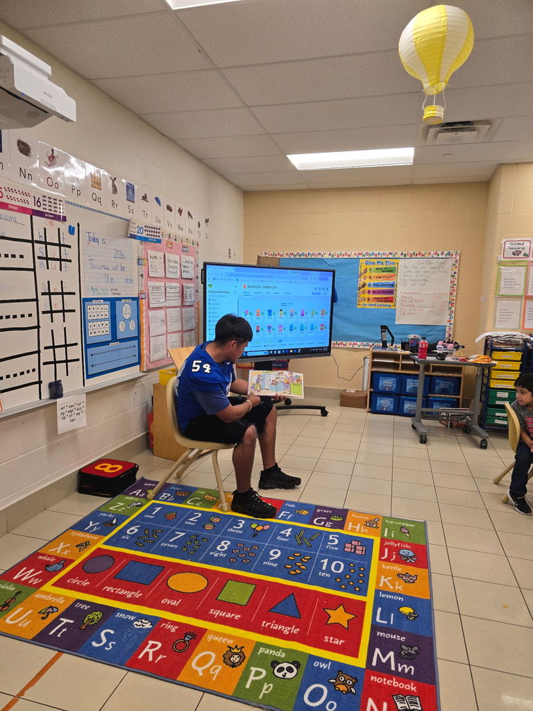 CHS Football team came in to GREET and read to our Kinder students.
