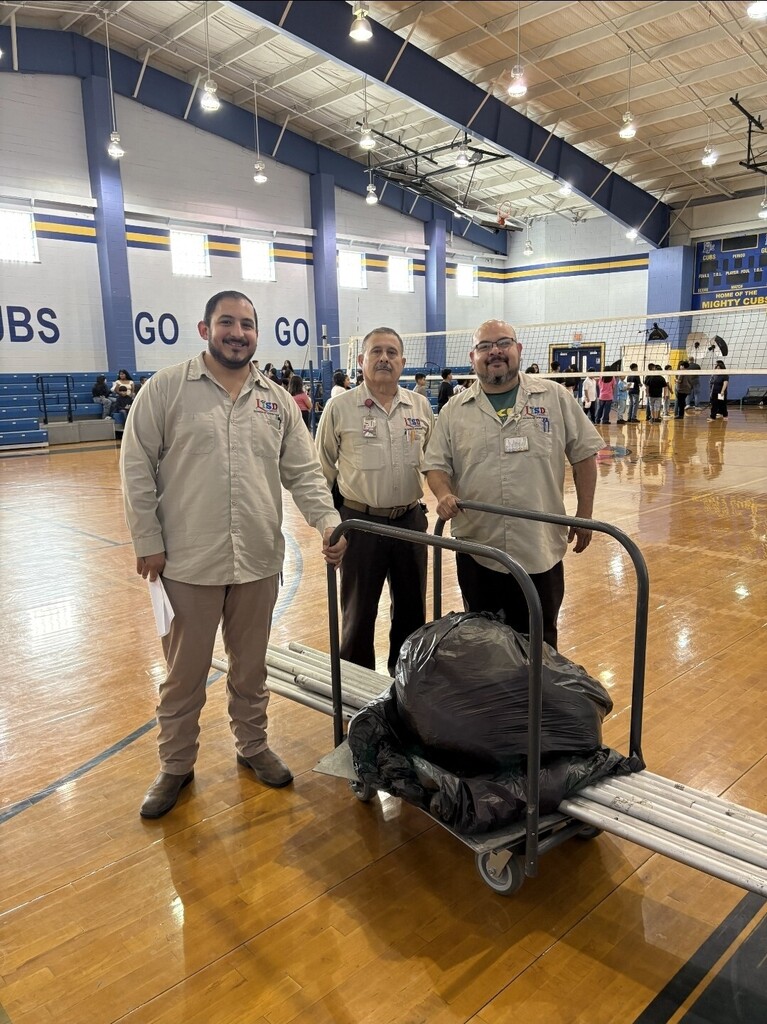 Division shipping and receiving crew helping out with partitions for 8th grade pictures.