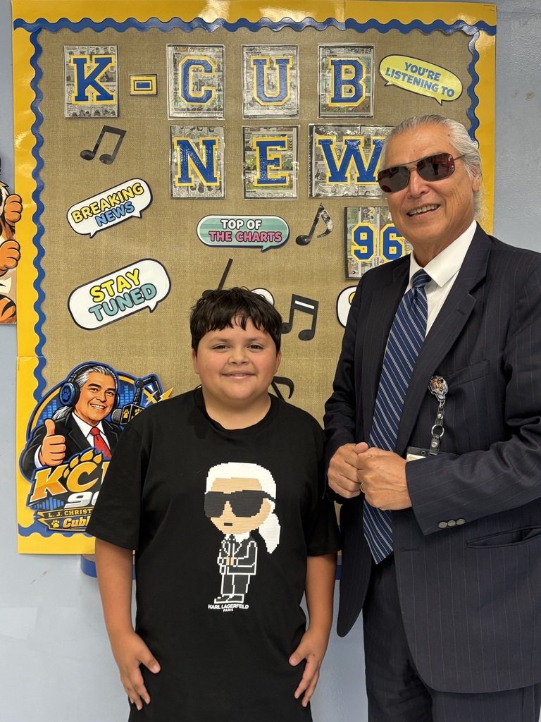 Principal Dr. Oscar Pérez and a student wearing a shirt with a character that looks like Dr. Perez.