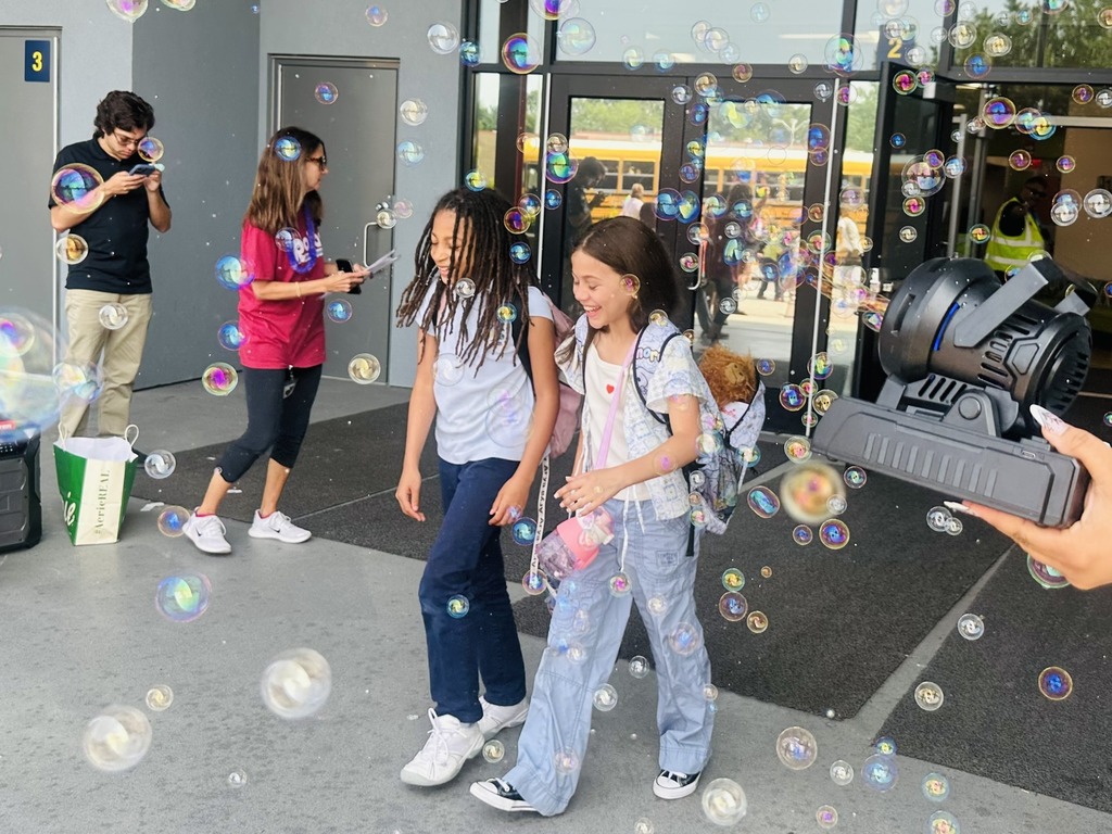 kids smiling walking out of building