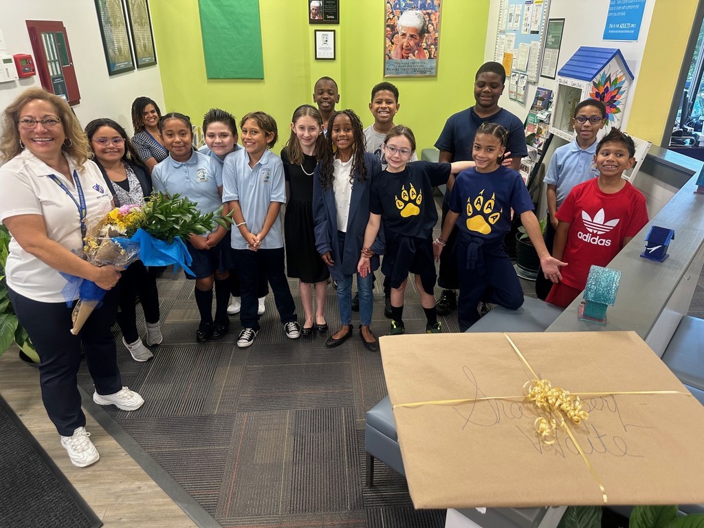MLW founders day students present flowers & card
