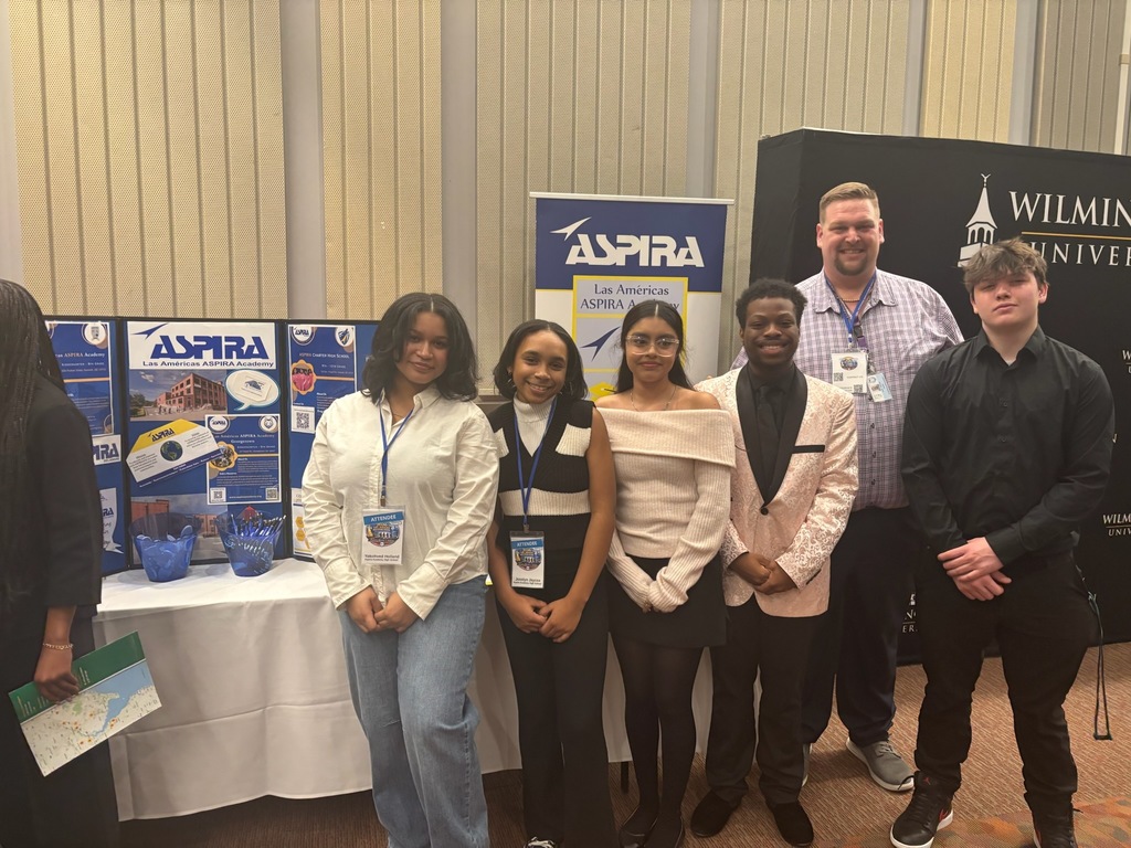 Students at edcon rising conference with ASPIRA table