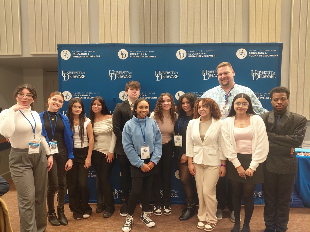 Students at edcon rising conference with ASPIRA table