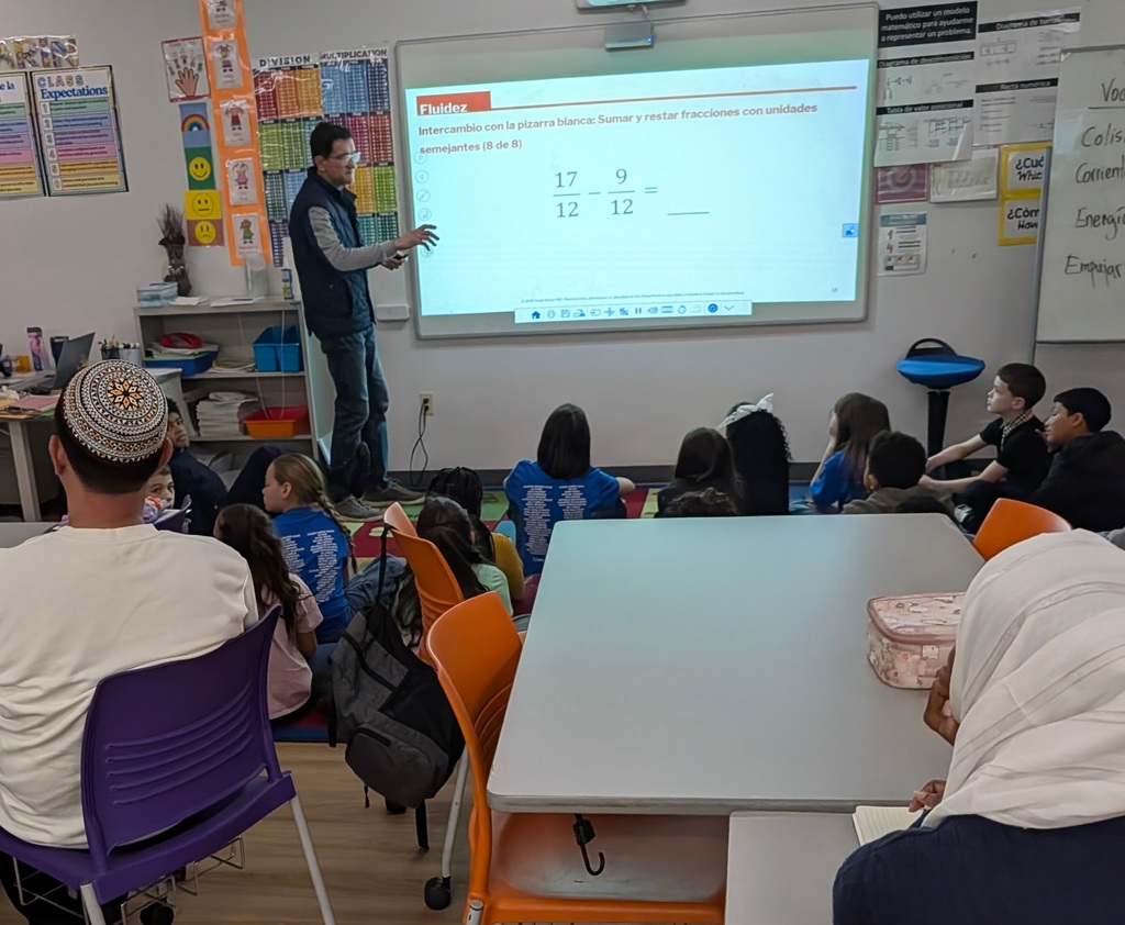 International students observing a 4th grade classroom