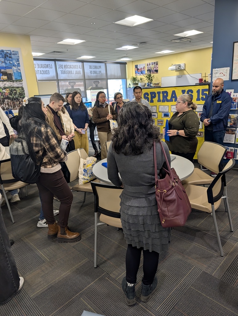 international students standing in a circle listening to the bilingual coach talking about the school