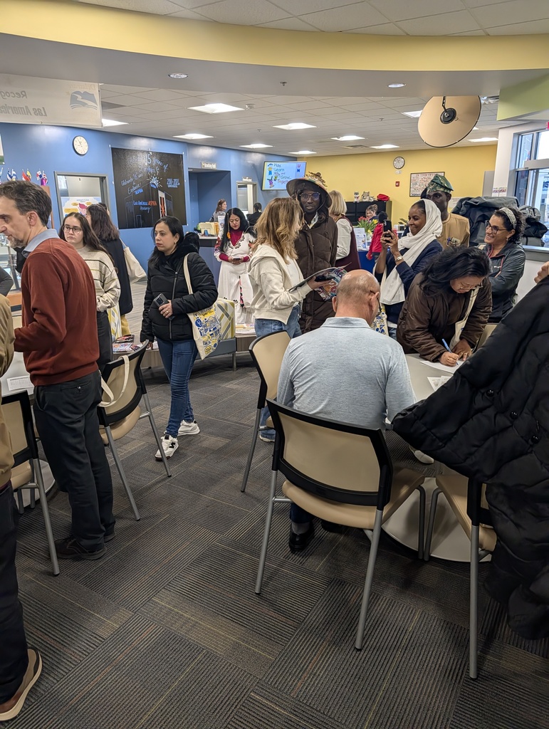 international students gathered in school foyer waiting to go and observe in classrooms