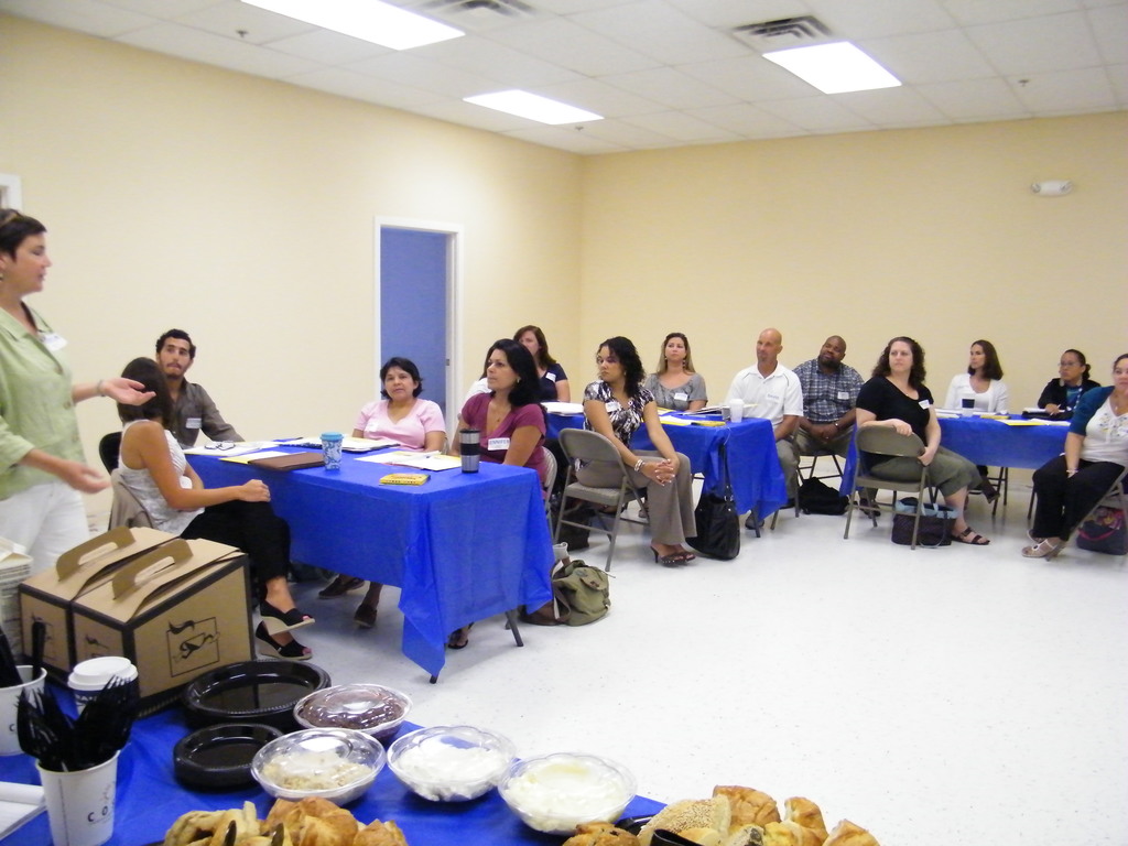 Throwback Thursday Picture of a staff PD day from 2011, showing a group of teachers sitting around desks and listening to a speaker.