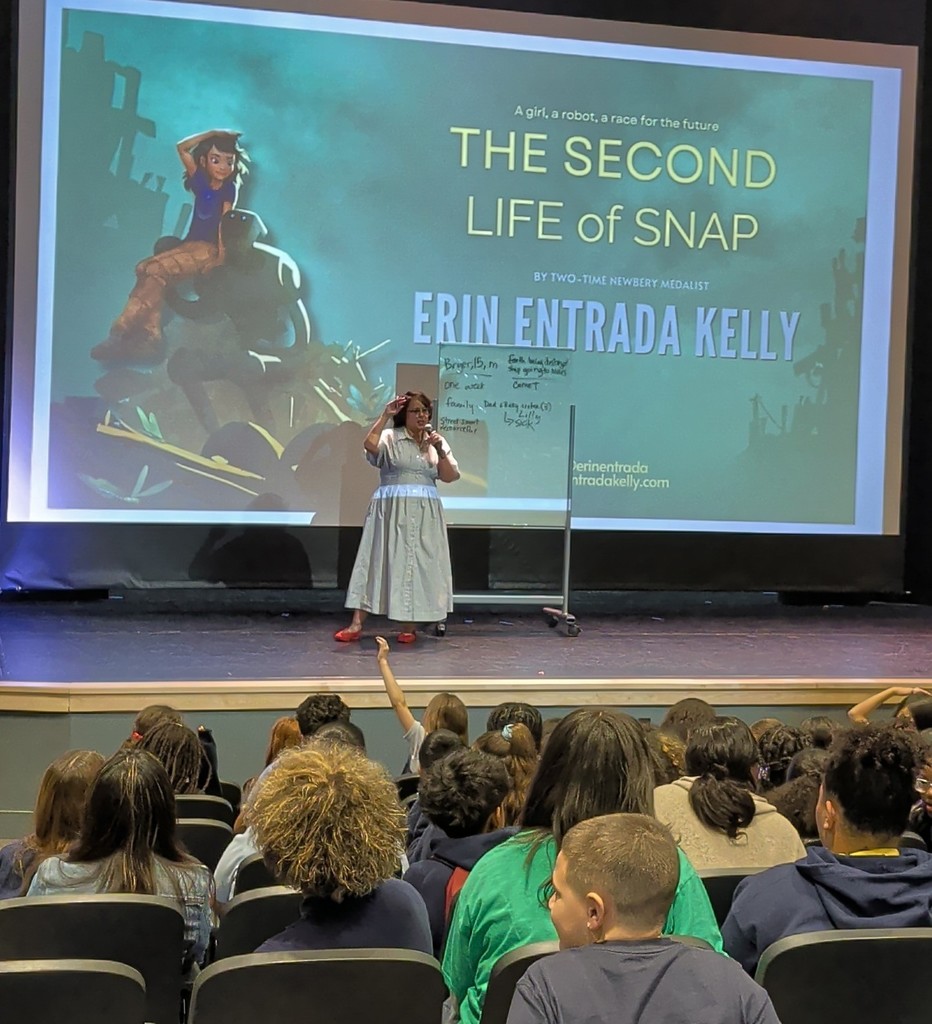 Author Erin Entrada Kelly on stage talking to ASPIRA students
