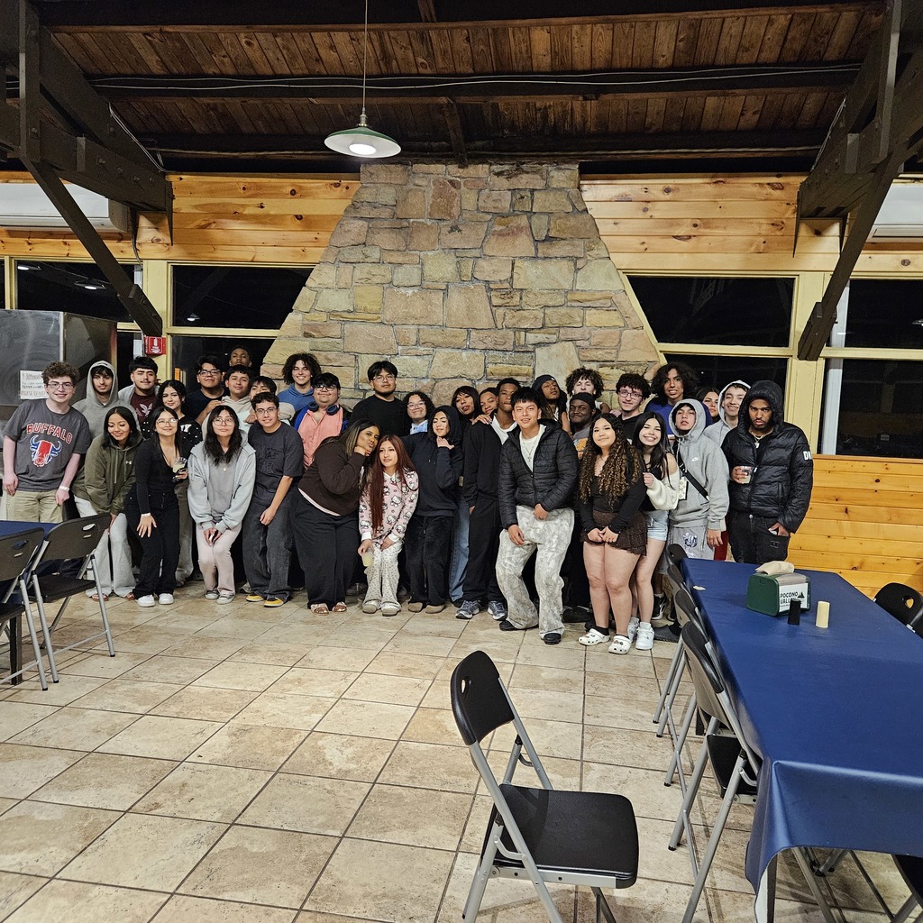 Senior trip to poconos students posing in front of fire