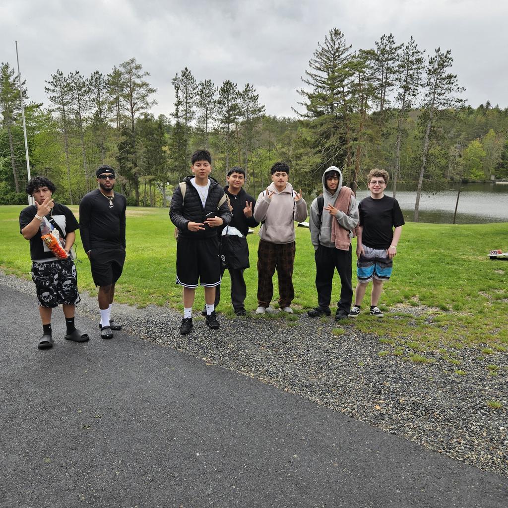 Senior trip to poconos students standing posing with trees in background