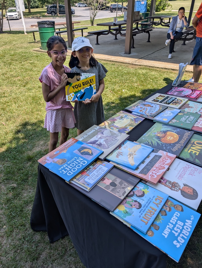 girls holding free books from library