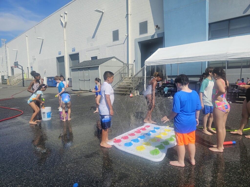 students cooling off with water games in the sun