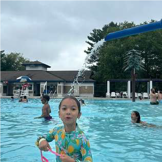 girl in pool with pink goggles