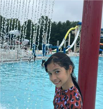 girl in pool under waterfall