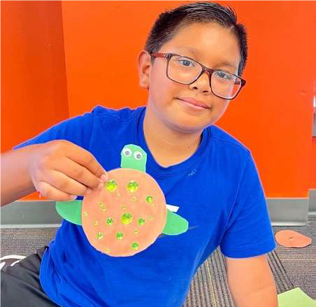 boy with paper turtle