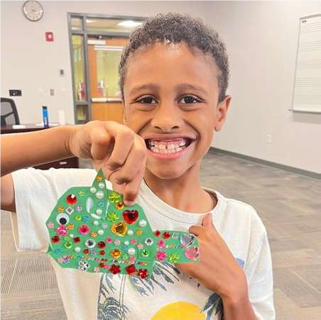 boy with paper fish with sparkles