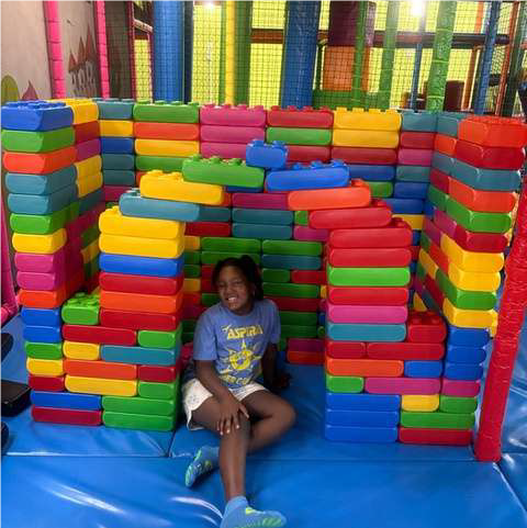 girl in large lego house