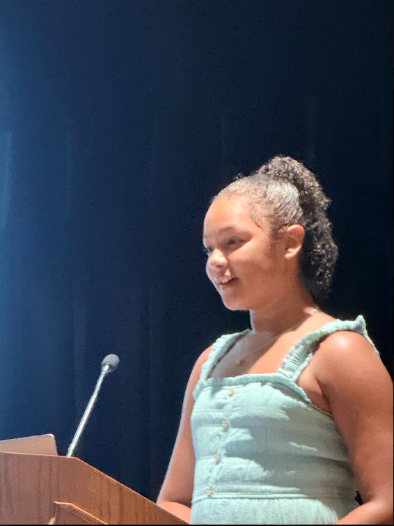 A'mira speaking at podium at AVID event