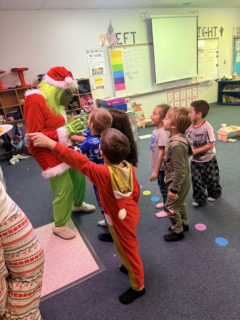 Kindergartner pics of visit from Santa and grinch