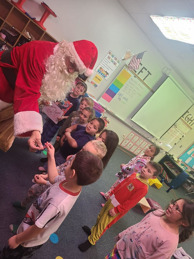 Kindergartner pics of visit from Santa and grinch