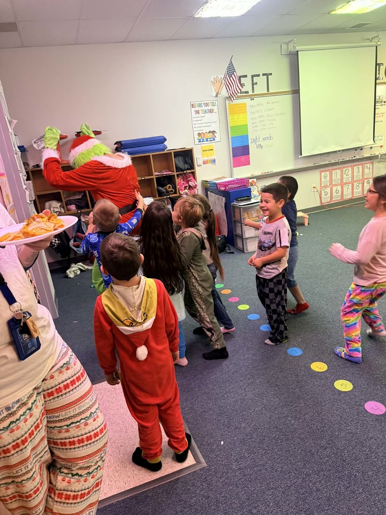 Kindergartner pics of visit from Santa and grinch