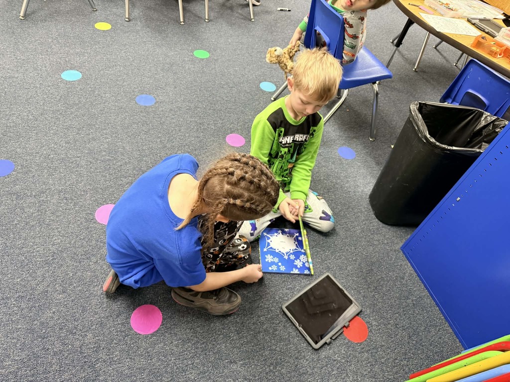 6th graders reading with the kindergartners 